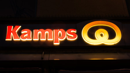 GIESSEN  GERMANY DECEMBER 2017: Illuminated Red Logotype of KAMPS.  KAMPS is a german bakery chain based in Schwalmtal Nordrhein Westfalen.のeditorial素材