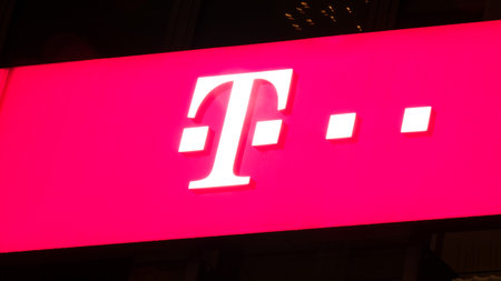 GIESSEN  GERMANY DECEMBER 2017: Illuminated pink Logotype of  Telekom.  Telekom is a telephone provider chain based in Bonn, Nordrhein-Westfalen.のeditorial素材