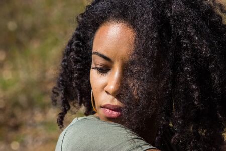 Portrait of an attractive African American woman. Outdoor shoot.