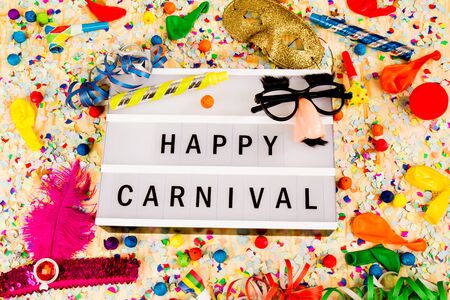 Lightbox with letters - HAPPY CARNEVAL - on colorful festive party decoration with steamers, confetti and ballons.の写真素材