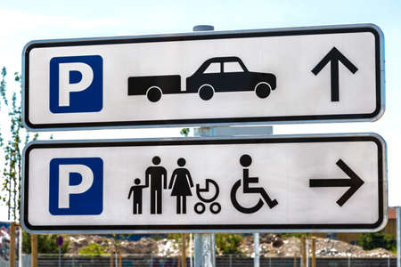 Signs for parking area with arrows outdoor shot in summerの写真素材