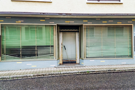 Closed bankrupt shop with closed blindsの写真素材