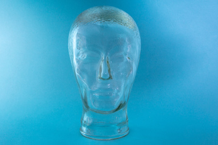 Glass Head Shape on bright blue backgroundの写真素材