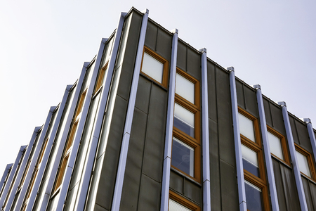 Office Building with a lot of Windows with bright sky