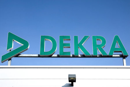WETZLAR - Germany- 25 March 2018 - Dekra logo on store front on blue sky background - Dekra is the automotive technical inspection chainのeditorial素材