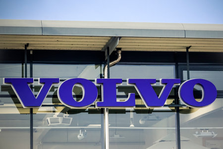WETZLAR, GERMANY- MARCH 25, 2018: Volvo Logo on a glass facade dealership sign against the blue sky. Volvo is a Swedish multinational automaker company headquartered in Gothenburg, Sweden.のeditorial素材
