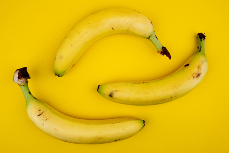 Fresh Bananas isolated on yellow Backgroundの写真素材