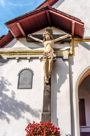 Jesus Christ Monument on a stone cross on a church fassadeのeditorial素材