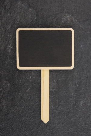 Blank little Blackboard on dark backgroundの写真素材