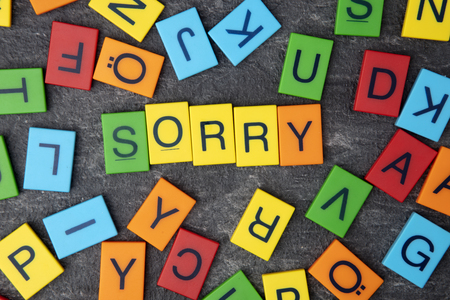 Sorry wrote with colorful toy letters on dark backgroundの写真素材