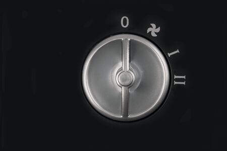Rotary Knob in detail on black backgroundの写真素材