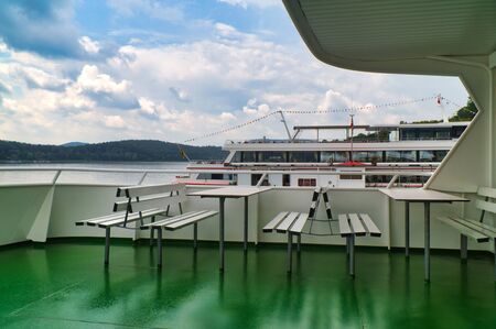 Benches on a passenger ship with clouds on Edersee