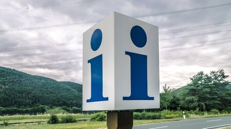 Information Sign on a cloudy day beneath a street in Germanyの写真素材