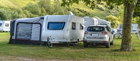 Air Tent with car and caravan on a natural campsiteの写真素材