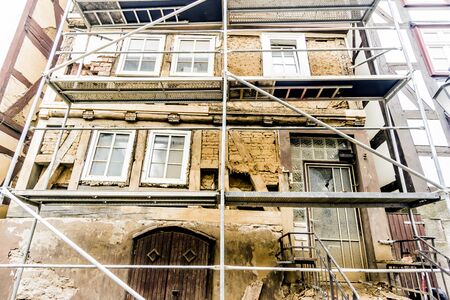 Scaffolding on an old dilapidated half-timbered houseの写真素材