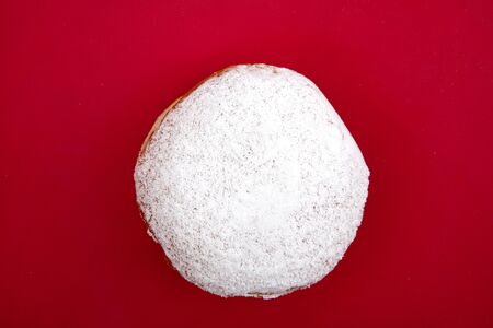 Culinary Berliner Donut on red background