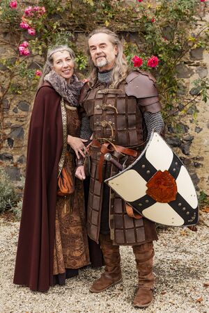 Couple posing robed in beautiful medieval clothing