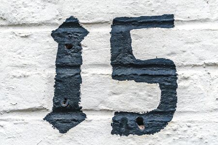 Number fifteen painted on a House Facade