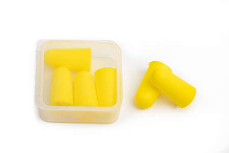 Yellow ear plugs isolated on a white background