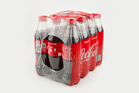 HUETTENBERB, GERMANY 2020-12-17: Wrapped Coca Cola Bottles on white background. Coca-Cola is a carbonated soft drink sold in stores throughout the world.のeditorial素材