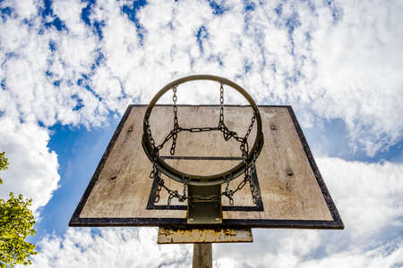 Weathered Basketball Hoop on a sunny day in summertimeの写真素材