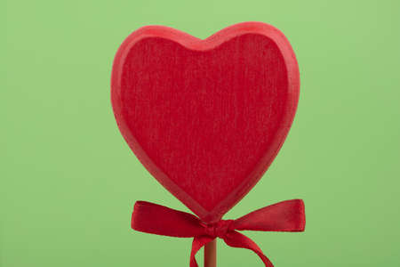 Decorative wooden Heart isolated on green backgroundの写真素材