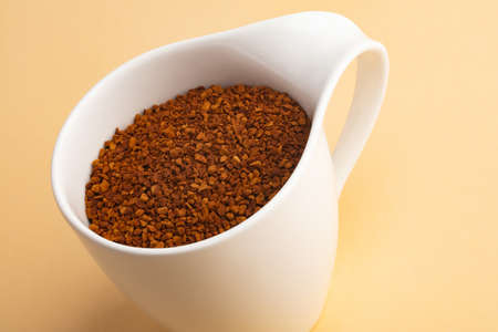 Powdered Coffee in a beautiful Coffee Cup on beige backgroundの写真素材