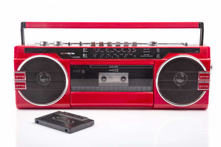 Red vintage Tape player isolated on white background with black cassette on frontの写真素材