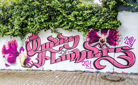 Awesome pink graffiti with lettering "Queens of Flowers" on a wallの写真素材