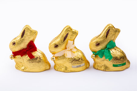 HUETTENBERG, GERMANY, 2021-04-04: Three Lindt Gold Bunny. Dressed in gold, with a ribbon and golden bell that rings, it is the traditional Lindt Easter chocolate.のeditorial素材