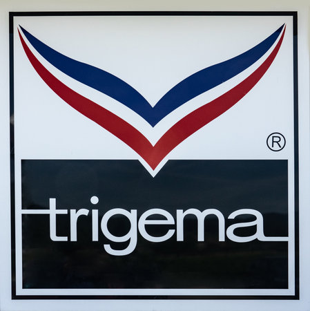 KIRCHHEIM, GERMANY -2019-07-10: TRIGEMA Logo Advertisement. TRIGEMA was established in 1919 and is Germany's largest manufacturer of sportswear and casual fashion.のeditorial素材