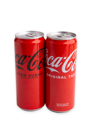 WETZLAR; GERMANY 2021-11-08: Coca Cola drink cans over white background. The drink is produced and manufactured by The Coca-Cola Company.のeditorial素材