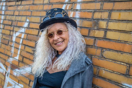 Beautiful Steam Punk Lady standing on a Brick Wall Backgroundの写真素材