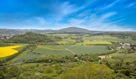 View on castle ruin vetzberg from the medieval castle ruin gleiberg in summertime with beautiful poppy meadowsの写真素材