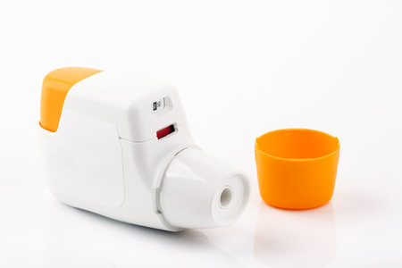 Metered dose of inhaler isolated over white background
