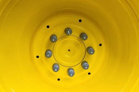 Screwing on a large wheel rim of a tractor in detail.の写真素材