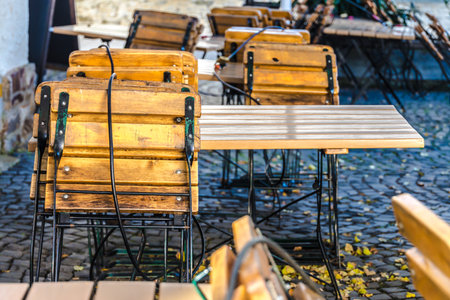 Fastened seats and tables in a front of a restaurantの写真素材