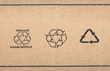 WETZLAR, GERMANY - 2022-07-16: Recycle signs printed on cardboard box in detail.のeditorial素材