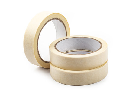 Rolls of beige adhesive tapes over bright backgroundの写真素材