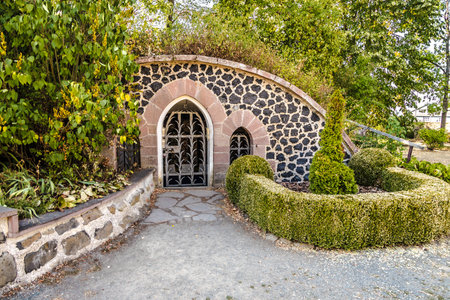 Oval archway with wrought iron gate in the park of Amoeneburg Castle.のeditorial素材