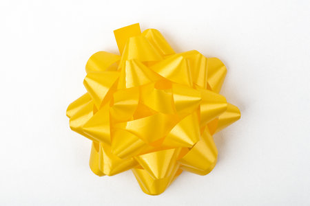 Top View from decorative yellow gift Bow isolated on white backgroundの写真素材