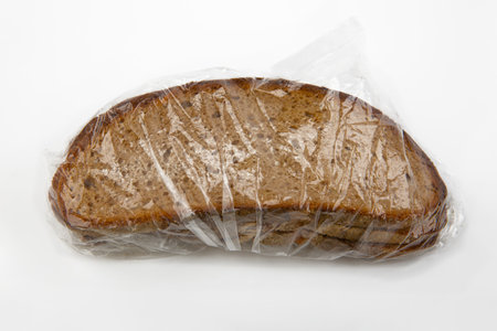 Slices of rye bread wrapped in cellophane foil with mold isolated over white background