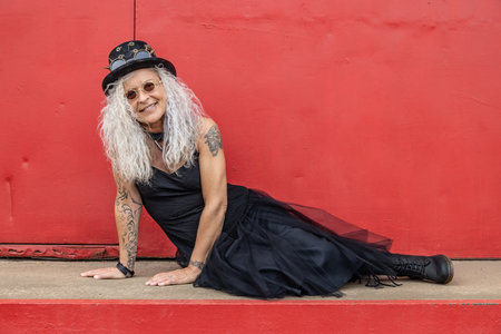 Beautiful steampunk lady on a old red wall backgroundの写真素材