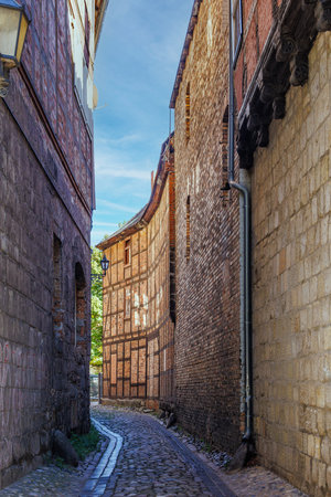 narrow alley with cobblestones in a small German townの写真素材