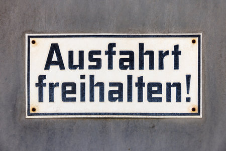 Weathered sign keep exit free, Ausfahrt freihalten in German language.の写真素材
