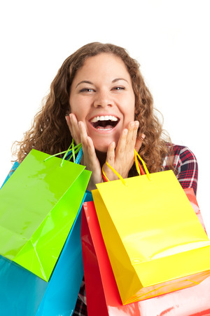 Young woman with her colorful bags is happy about shopping discounts. Black friday concept.の写真素材