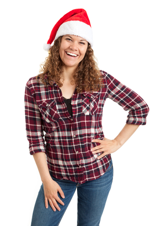 Woman in Santa hat posing isolated on white background. Mixed race caucasian girl happy looking at camera.の写真素材