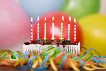 Colorful birthday party cake with candles. Birthday, party and family concept.の写真素材