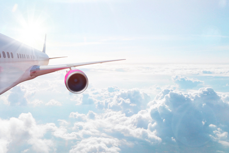 Airplane flying high above the clouds. Transportation, vacation and travel concept.の写真素材