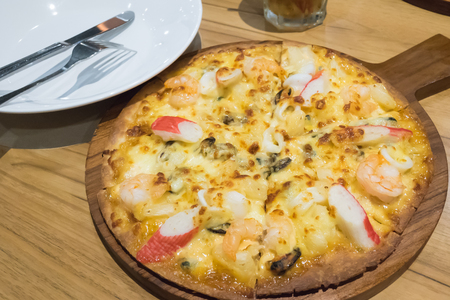 pizza thin under warm lightの写真素材